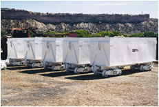 Eight-cubic-yard capacity lift off muck cars for a job in Dallas